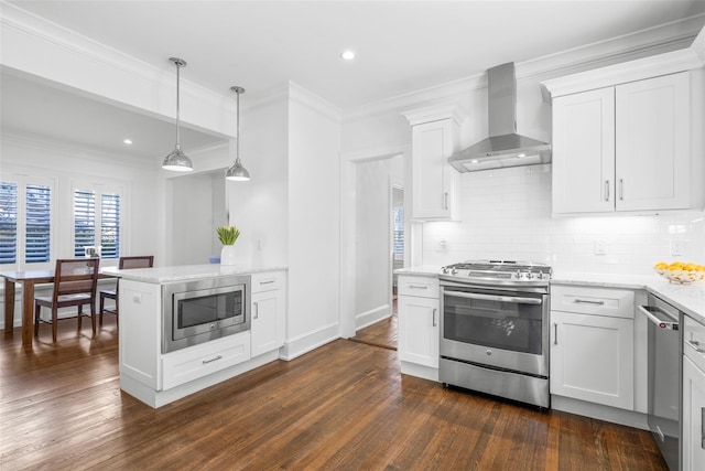 kitchen featuring wall chimney range hood, tasteful backsplash, stainless steel appliances, and dark wood-type flooring