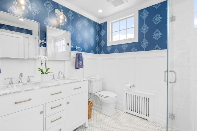 bathroom featuring wallpapered walls, wainscoting, a sink, and radiator