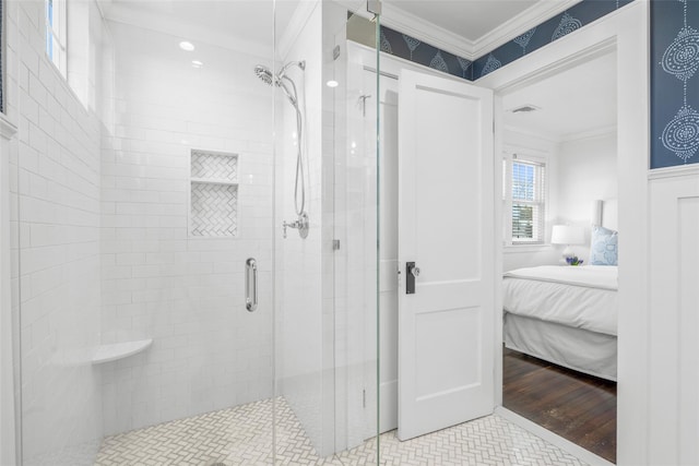 ensuite bathroom with a stall shower, visible vents, crown molding, and ensuite bathroom