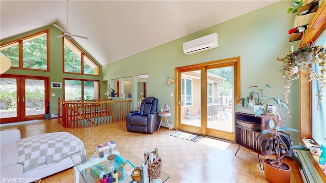 living room with french doors, light parquet floors, a wall mounted AC, ceiling fan, and high vaulted ceiling