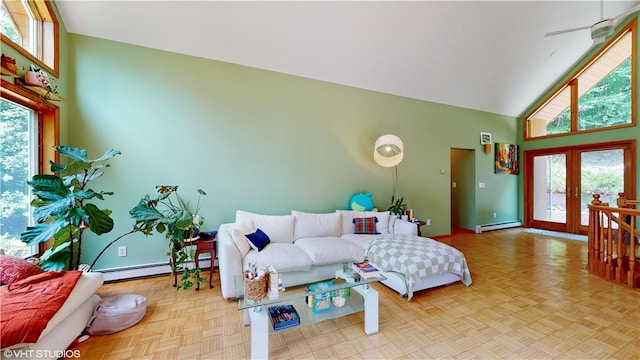 living room with plenty of natural light, baseboard heating, and high vaulted ceiling