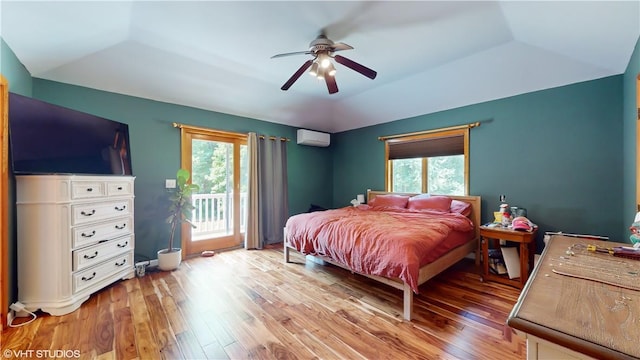 bedroom featuring access to exterior, light hardwood / wood-style flooring, an AC wall unit, and ceiling fan