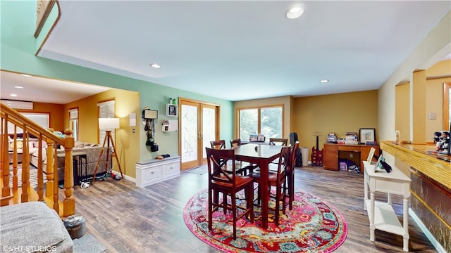 dining room featuring french doors, dark hardwood / wood-style floors, and a wall mounted AC