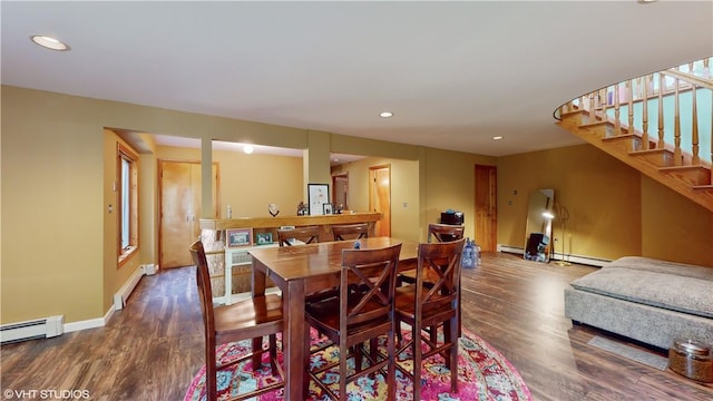 dining area with hardwood / wood-style floors and a baseboard radiator