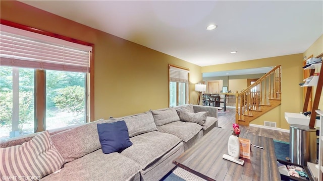 living room featuring a wealth of natural light and wood-type flooring