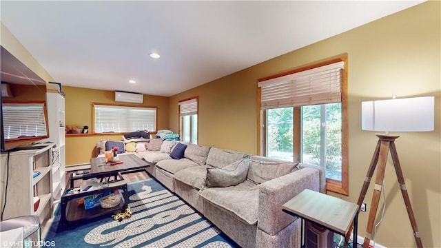 living room with an AC wall unit and baseboard heating