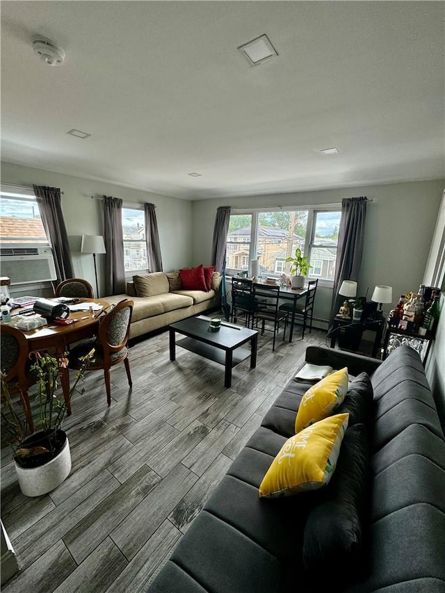 living room with wood-type flooring, a wealth of natural light, and cooling unit