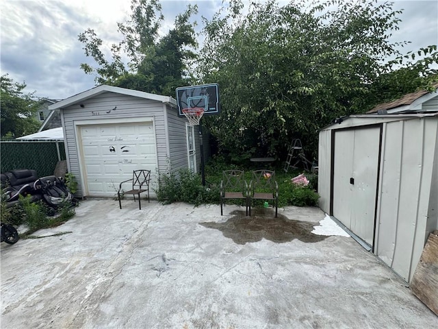 view of patio / terrace with a garage and an outdoor structure