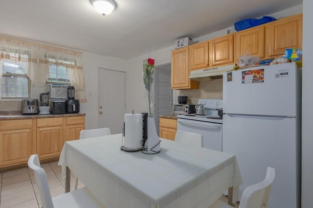 kitchen featuring tile counters, light brown cabinets, white appliances, and light tile patterned floors