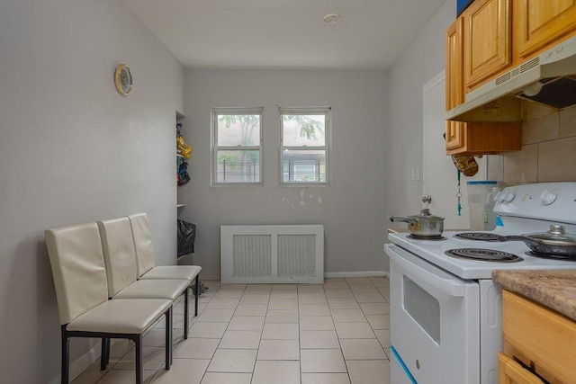 kitchen featuring white electric range, radiator heating unit, and light tile patterned flooring