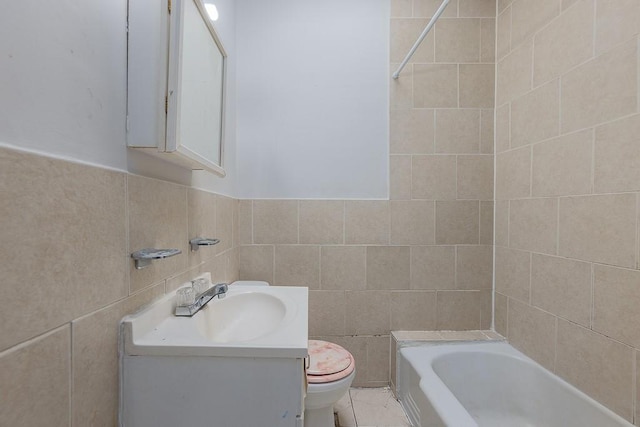 full bathroom featuring tile patterned floors, vanity, tiled shower / bath combo, tile walls, and toilet