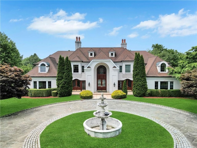 view of front facade featuring french doors and a front lawn