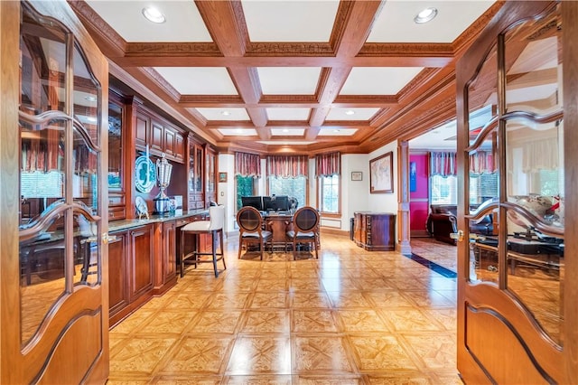 interior space featuring beamed ceiling, light parquet floors, crown molding, and coffered ceiling