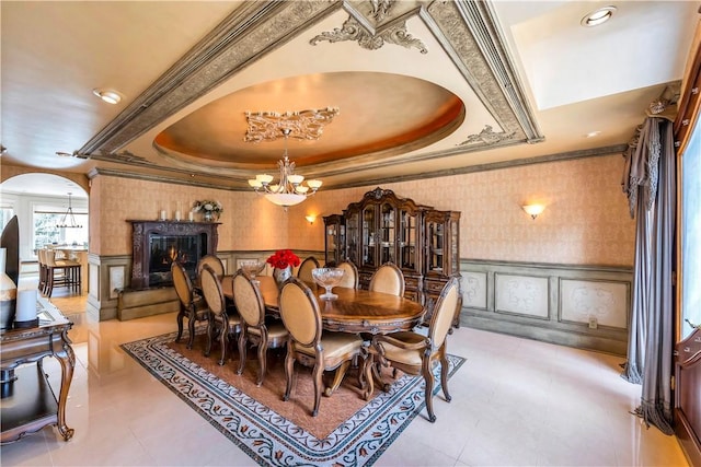 dining area featuring a tray ceiling and crown molding