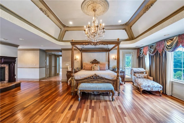 bedroom with multiple windows, crown molding, an inviting chandelier, and hardwood / wood-style flooring