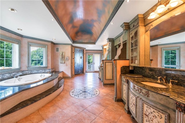 bathroom with tile patterned floors, vanity, crown molding, and tiled bath