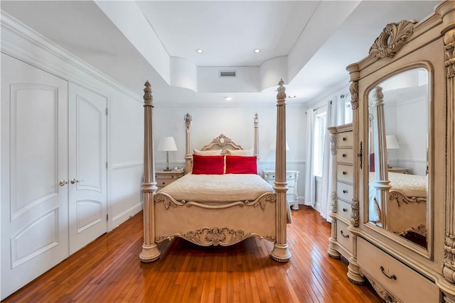 bedroom featuring crown molding, a closet, and hardwood / wood-style flooring