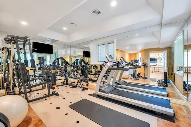 workout area featuring a tray ceiling