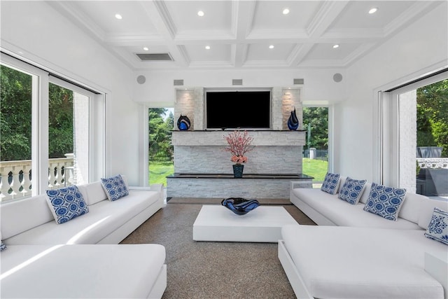 living room with beam ceiling, a wealth of natural light, and coffered ceiling