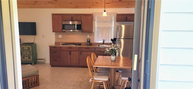 kitchen with sink, wood ceiling, decorative light fixtures, and appliances with stainless steel finishes