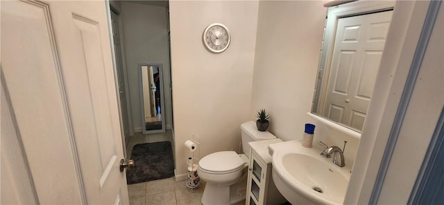 bathroom featuring tile patterned flooring, toilet, and sink