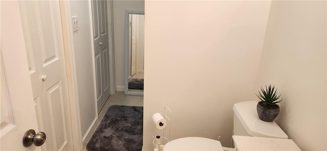 bathroom with tile patterned flooring and toilet