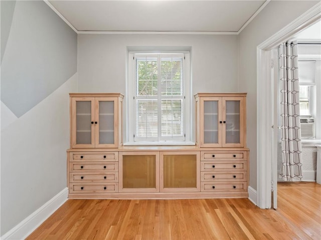 interior space with light hardwood / wood-style flooring and ornamental molding