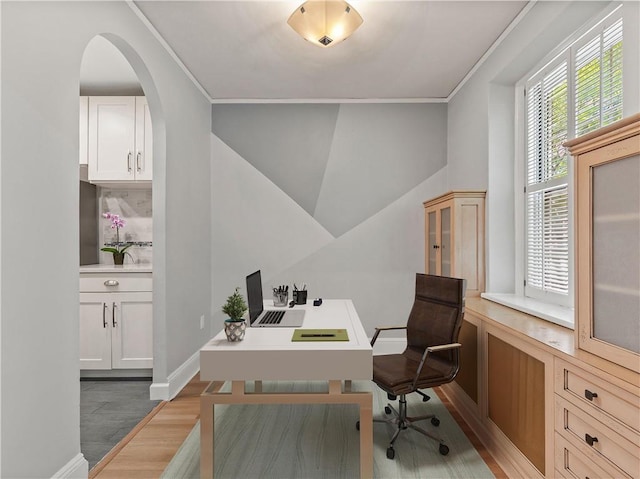 office area with hardwood / wood-style flooring and crown molding