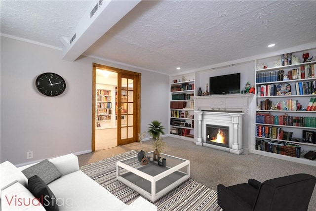 carpeted living room featuring built in features, a textured ceiling, and french doors