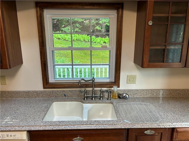 437 Lindholm Rd, Fallsburg, NY 12747 - kitchen with glass insert cabinets, a sink, and light stone countertops