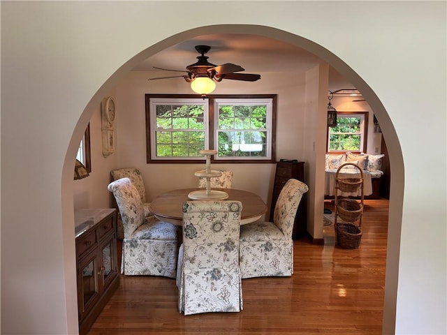437 Lindholm Rd, Fallsburg, NY 12747 - dining area featuring wood finished floors, a ceiling fan, and arched walkways