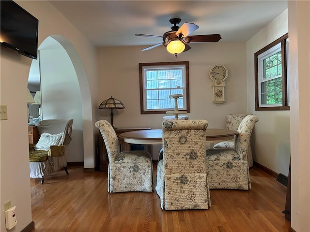 437 Lindholm Rd, Fallsburg, NY 12747 - dining space with wood finished floors, ceiling fan, baseboards, and arched walkways