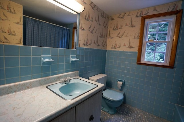 437 Lindholm Rd, Fallsburg, NY 12747 - full bath with wallpapered walls, toilet, a wainscoted wall, vanity, and tile walls