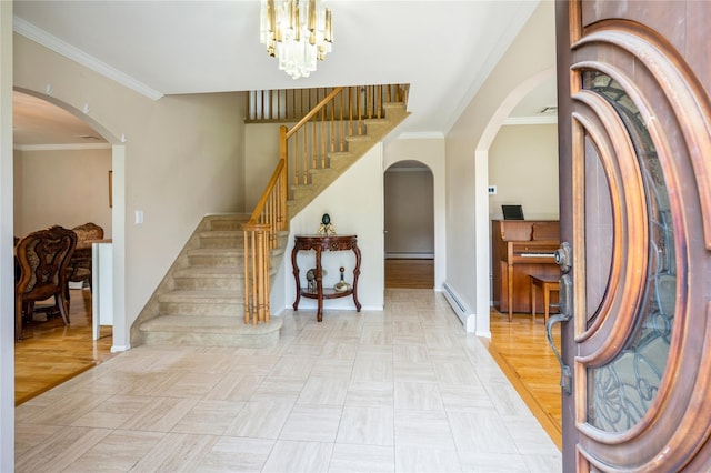 foyer entrance with crown molding, light hardwood / wood-style flooring, a baseboard heating unit, and a notable chandelier