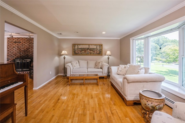 living room with a brick fireplace, light wood-type flooring, crown molding, and a baseboard heating unit