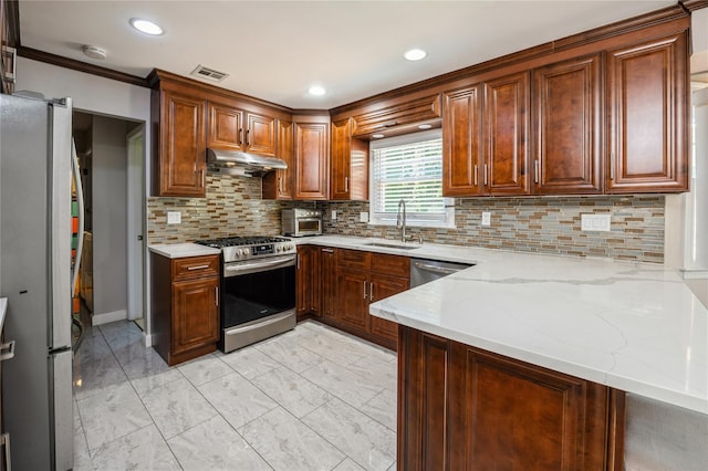 kitchen with sink, tasteful backsplash, light stone counters, kitchen peninsula, and stainless steel appliances