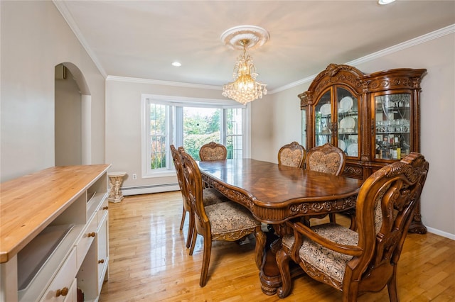 dining room with crown molding, light hardwood / wood-style flooring, a notable chandelier, and a baseboard heating unit