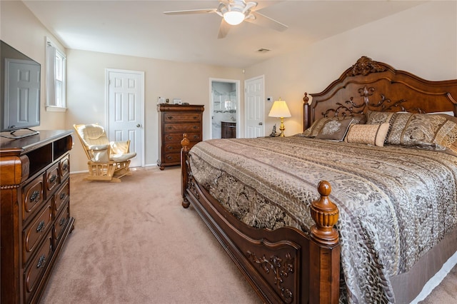 carpeted bedroom with connected bathroom and ceiling fan