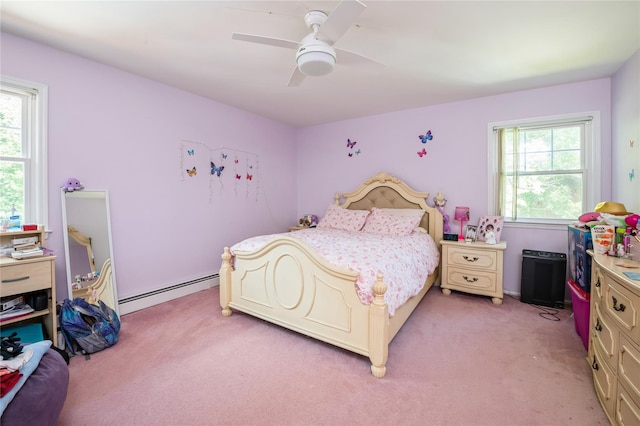 bedroom featuring multiple windows, light colored carpet, baseboard heating, and ceiling fan