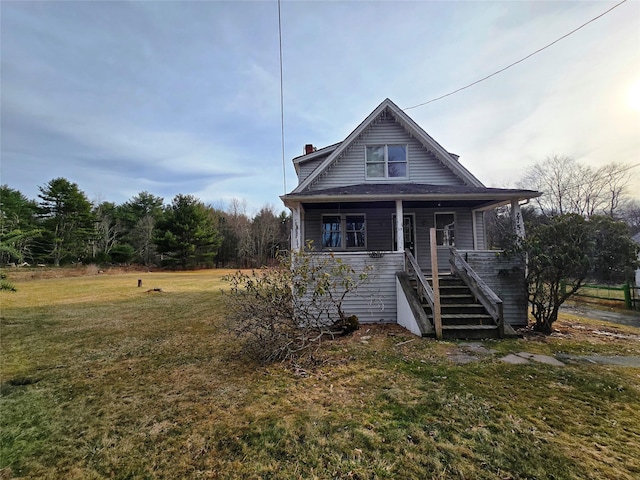 275-277 State Route 17b, Monticello, NY 12701 - bungalow-style house featuring a front lawn, a porch, and stairs