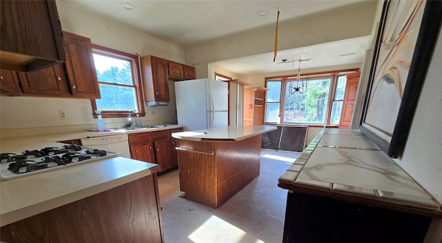 275-277 State Route 17b, Monticello, NY 12701 - kitchen with a sink, plenty of natural light, white appliances, light countertops, and a kitchen island