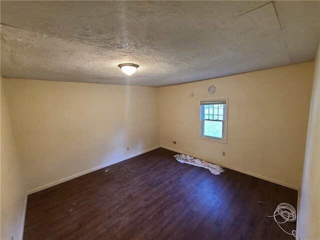 275-277 State Route 17b, Monticello, NY 12701 - unfurnished room featuring dark wood finished floors, baseboards, and a textured ceiling