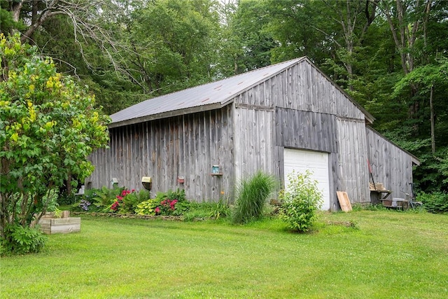 view of outbuilding featuring a yard