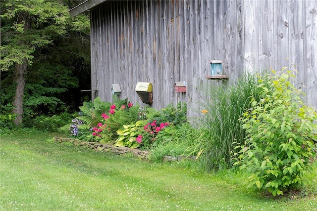 view of side of property with a lawn