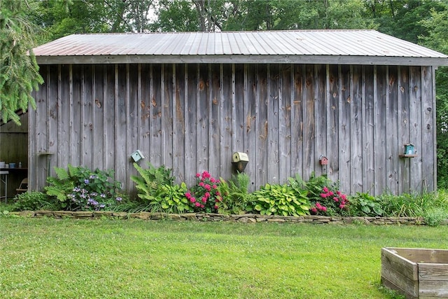 view of outbuilding with a yard