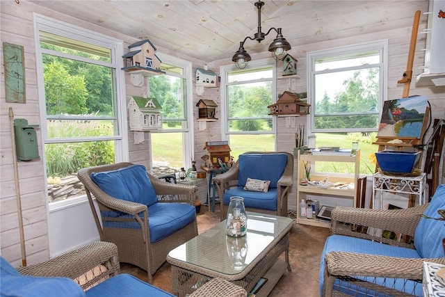 sunroom / solarium with vaulted ceiling and a healthy amount of sunlight