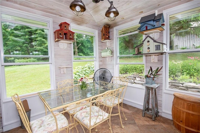 sunroom with lofted ceiling and wood ceiling