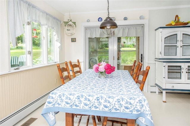 dining room with ornamental molding and a baseboard heating unit