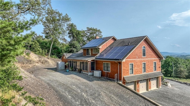 view of home's exterior featuring solar panels and a garage