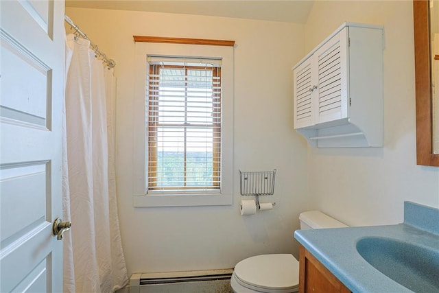 bathroom featuring vanity, toilet, and baseboard heating